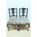A pair of late 19th Century upholstered and carved mahogany salon standard chairs