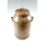 A turned coopered oak storage vessel in the form of a milk churn with a turned lift off lid,