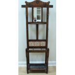 A late 19th / early 20th Century oak hall stand, having a mirror back and decorated with insert