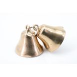 A 9 ct gold charm modelled as a pair of bells, complete with clappers, each 1 cm, 1.2 g