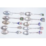 Ten silver and enamelled silver souvenir teaspoons, relating to Lincoln, Derby, Norwich etc, 138 g