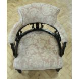 A late 19th Century upholstered and carved mahogany horseshoe back lounge armchair