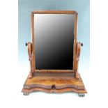 A Victorian mahogany toilet mirror, having serpentine platform base and scroll uprights, 60 x 29 x