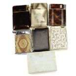 A group of vintage combination cigarette case and lighters, including one bound in gilt tooled