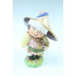 A 19th Century Derby type Mansion House dwarf, modelled in flamboyant 17th Century dress, his hat