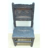 A Victorian carved oak hall chair, the carved back having twisted wrought iron brackets, 46 x 43 x