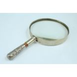 A late 19th / early 20th Century magnifying glass having a handle fabricated from a Border