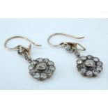 An elegant pair of early 20th Century daisy set diamond ear pendants, each set with old cut