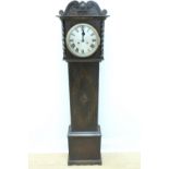 A 1930s oak grandmother clock, the movement striking on a gong and having a silvered dial, key