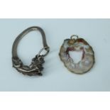 An agate slice pendant together with a white metal key loop in the form of a dragon head, latter