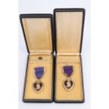 Two US Purple Heart medals, cased