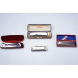 Four Hohner harmonicas, comprising 'The Chromonica', 'Super Chromonica', '64 Chromonica' and '
