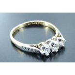 A three stone diamond ring, having three graduated brilliant diamonds (approximately .25 carat),