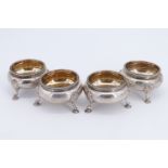 A set of four Victorian gilt lined silver salt cellars, of oblate form having a beeded rim, shell