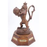 A large and impressive Cunard Line carved oak crest, a rampant lion holding a globe aloft stood upon