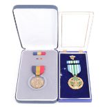 A US Joint Services Commendation Medal, together with a Navy and Marine Corps Medal, cased