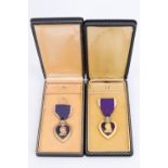 Two US Purple Heart medals, cased