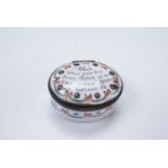 An 18th Century Bilston enamel patch box, of oval form decorated with ribbons and laurel swags,
