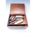 A vintage hinge lidded box containing a quantity of boot brushes, 40 x 32 x 22 cm