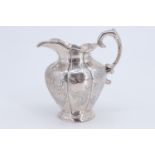 A 19th Century Irish silver milk jug, of shouldered melon form with bright cut decoration and a