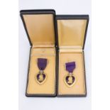 Two US Purple Heart medals, cased