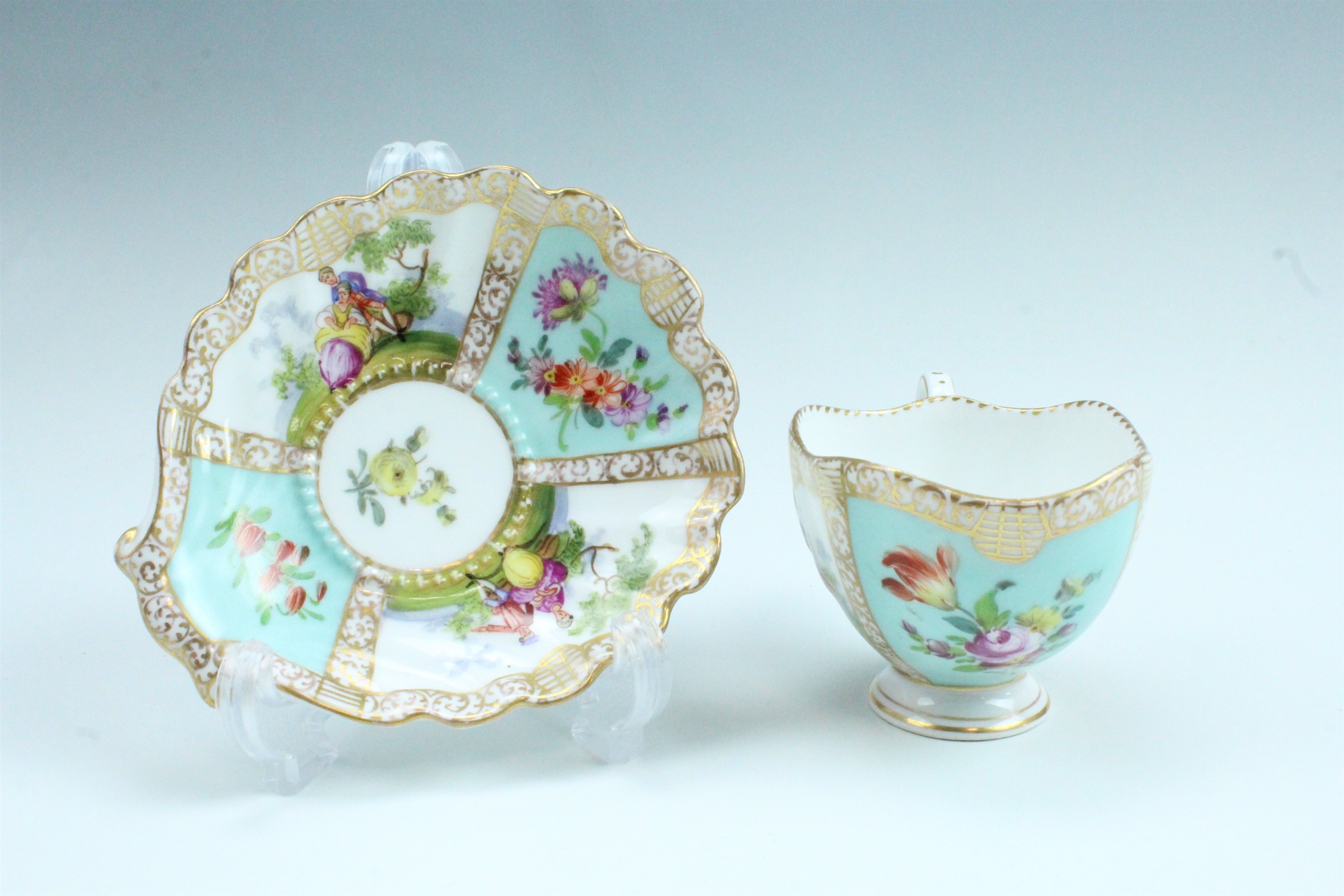 A 19th Century Dresden cabinet cup and saucer, having floral decoration and classical scenes of - Image 2 of 2