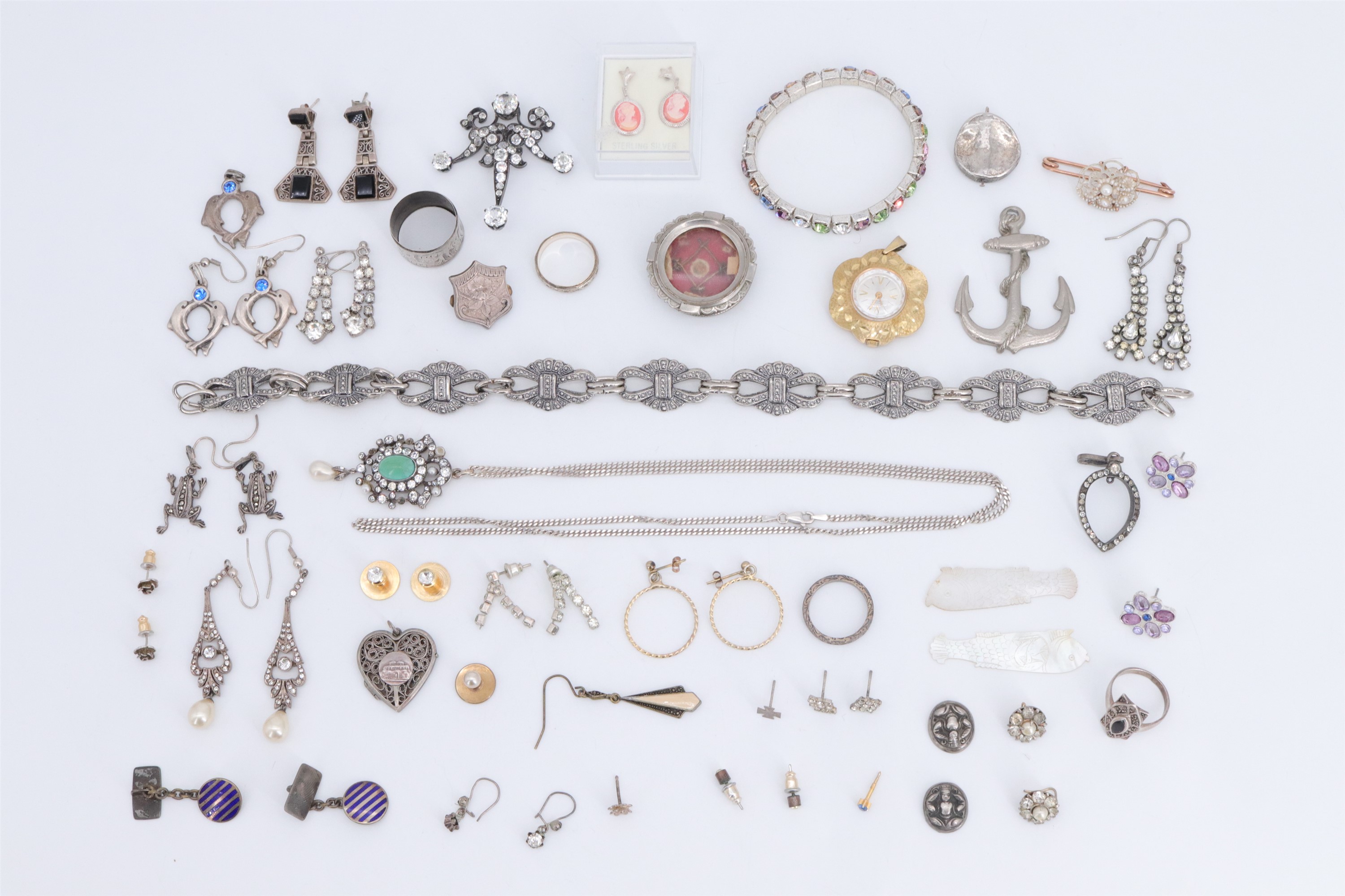 A group of vintage white metal and other costume jewellery, together with a religious relic and