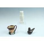A Belleek owl, having a black backstamp, a small Royal Doulton Toby jug, and an iridescent glass