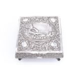 A belle epoque silver table box, profusely decorated with repousse scrolls, the top bearing a