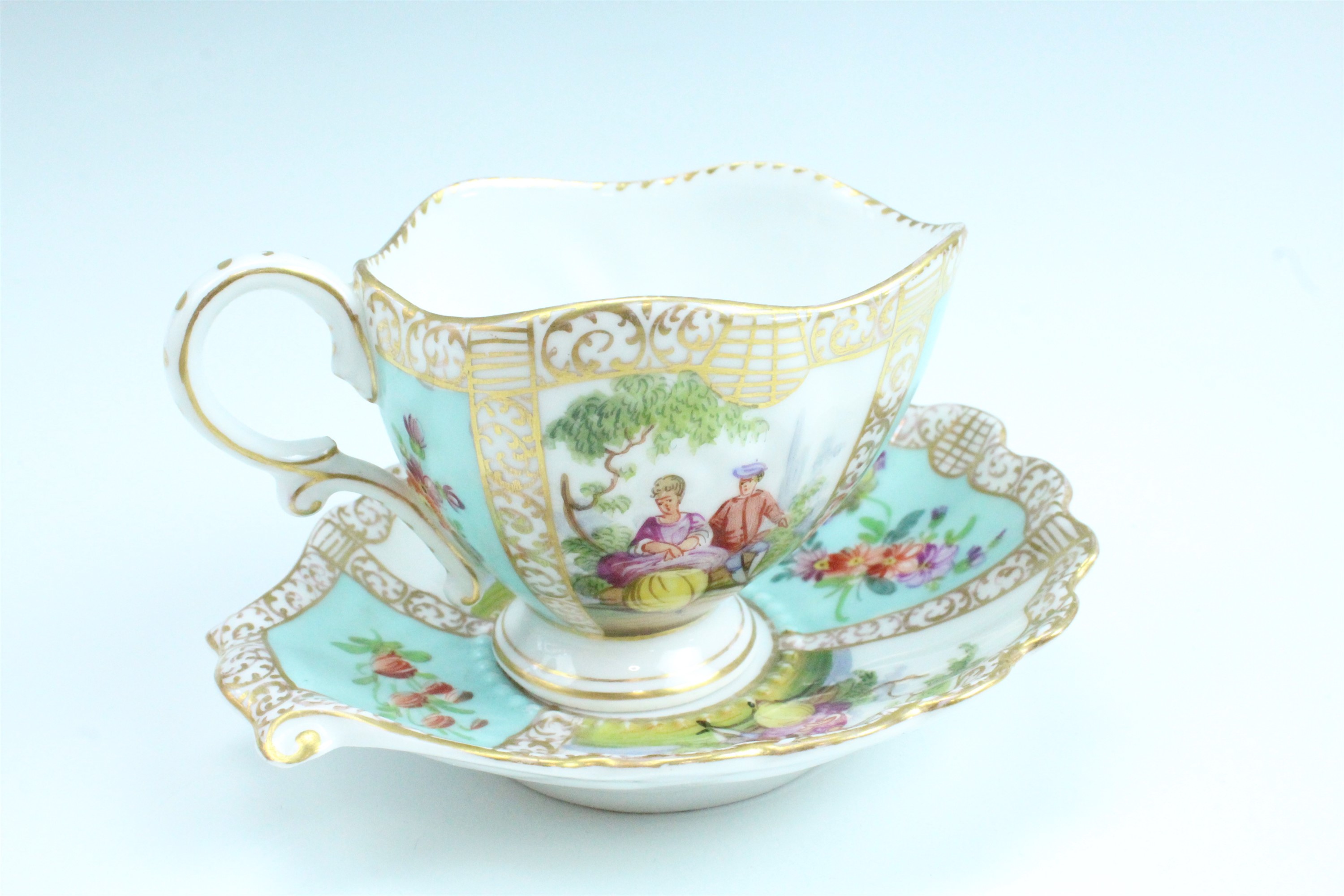 A 19th Century Dresden cabinet cup and saucer, having floral decoration and classical scenes of