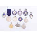 11 silver and enamelled silver fob medallions and one badge, relating to shooting and rifle clubs