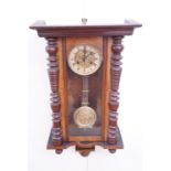 An early 20th Century walnut Vienna wall clock, spring driven movement striking on a gong, having