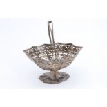 An Edwardian silver swing handled bob bon basket, of navette shape and having fluted sides with