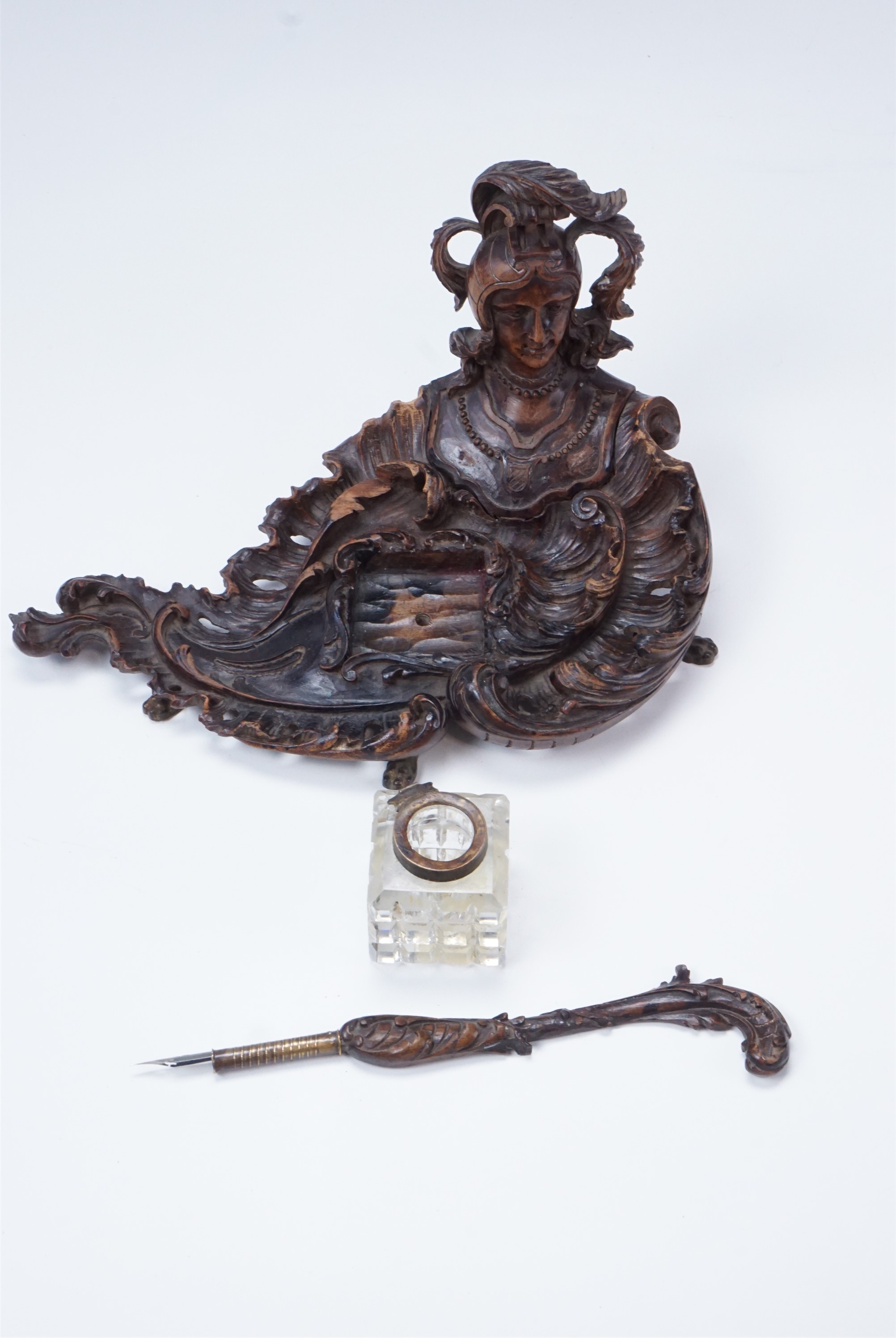 A finely carved late 19th / early 20th Century walnut ink standish, of rococo form having a helmeted - Image 2 of 2