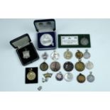 Four white metal and enamelled white metal fob medallions, tested as silver, together with a
