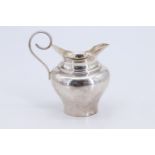 A late Victorian silver cream jug, of shouldered ovoid form having an adorsed flared neck with a