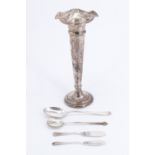 An Edwardian silver trumpet vase, a trefid spoon, a Hanoverian pattern spoon, and two butter knives,