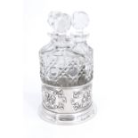 An Edwardian dressing table perfume bottle set, in cut glass with lapidary stoppers, nestling in a