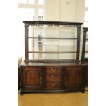 An 18th Century Cumberland oak dresser, having fielded panelled doors and fluted architectural