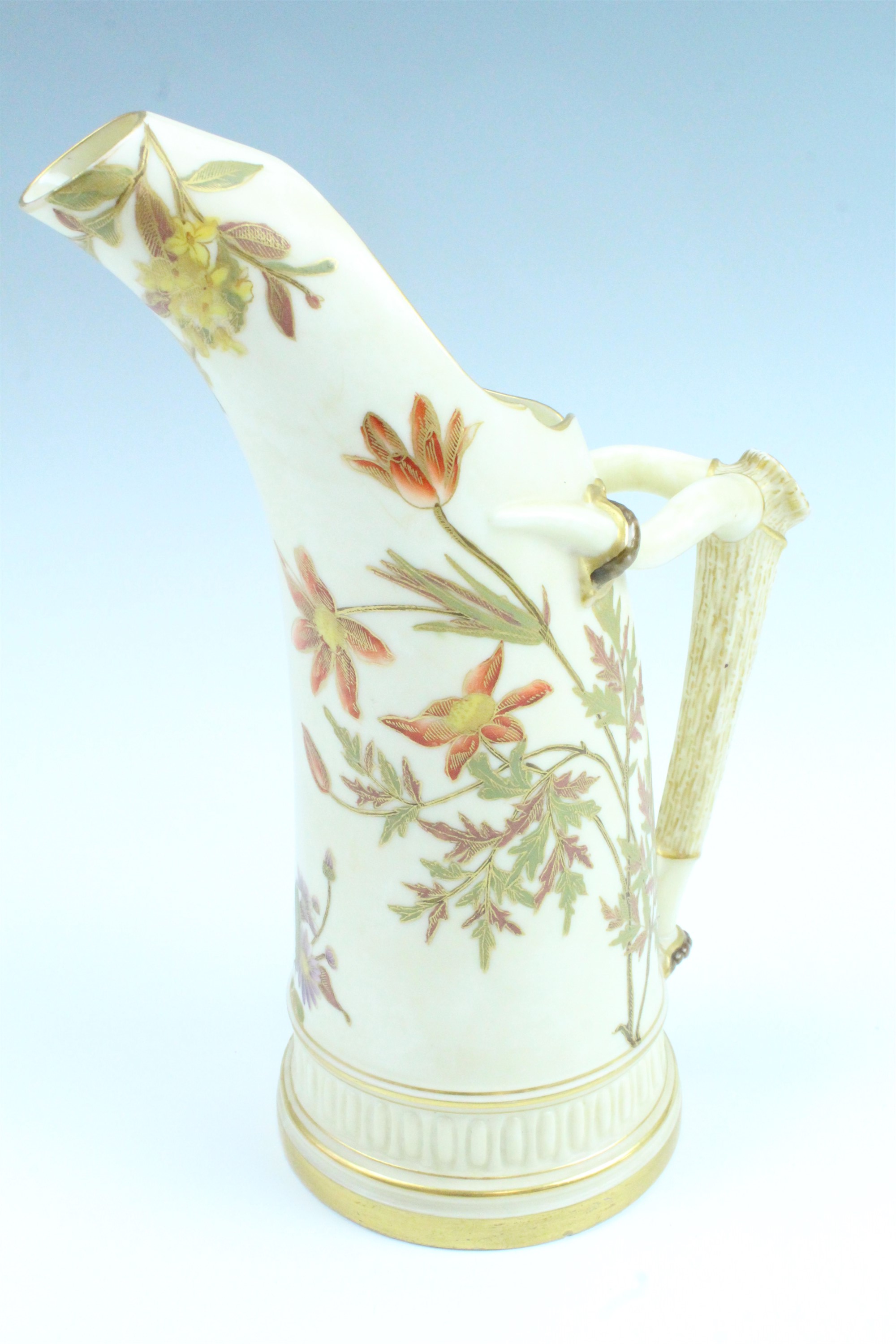 An early 20th Century Royal Worcester tusk jug / ewer, having an antler handle and floral
