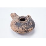 A Roman terracotta oil lamp, of oblate form having a central filling hole, 10.5 x 7.5 x 4 cm