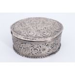 A Victorian silver oval lidded box, being profusely chased with scrolls, Birmingham, 1887, 47 g, 7.5
