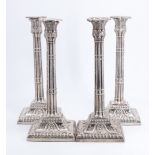 A set of four George III silver candlesticks, each having reeded columns with foliate capitals