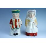 A pair of 19th Century Staffordshire earthenware Punch and Judy character jugs, having polychrome
