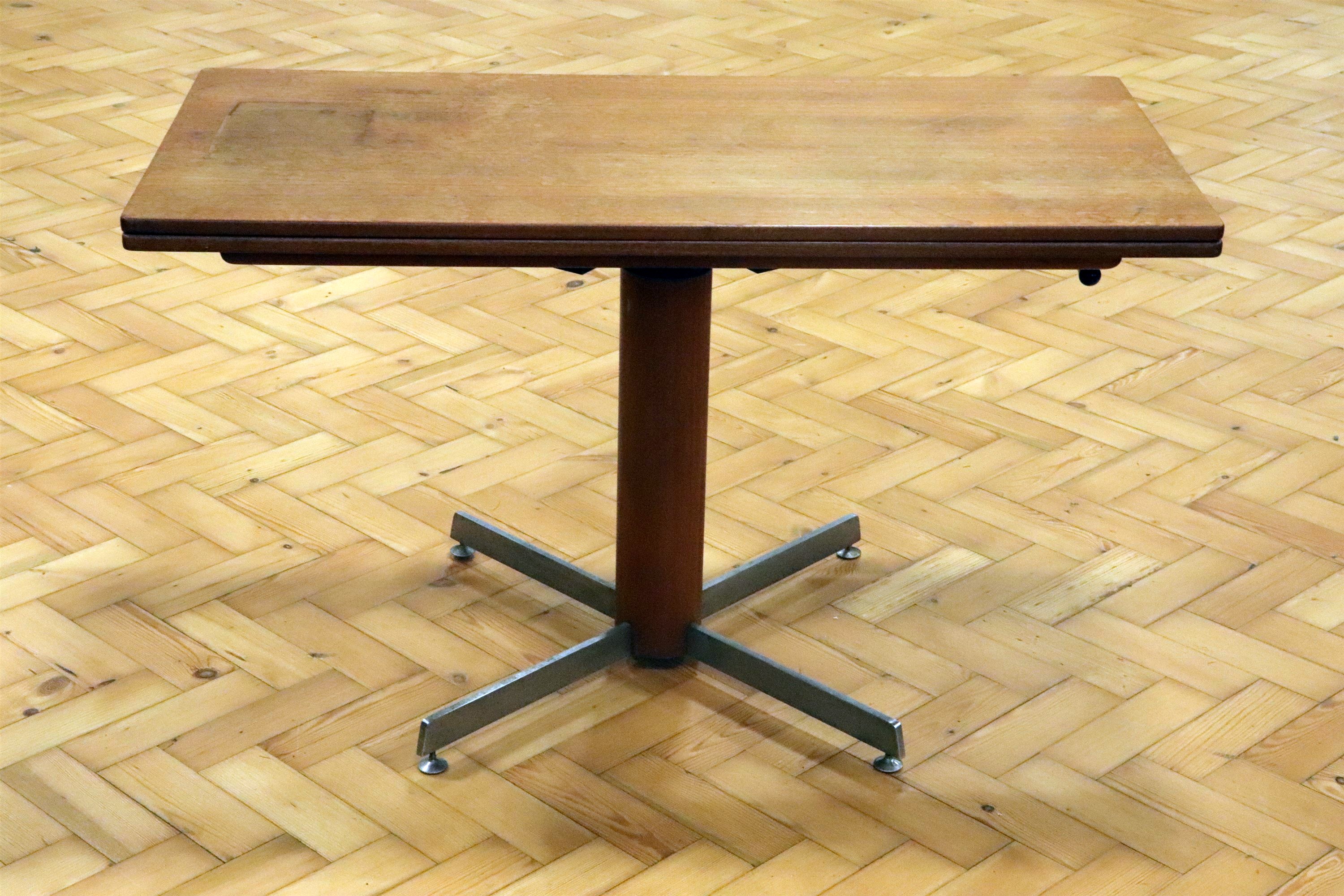 A teak and stainless steel height adjustable turn-over-top dining and coffee table, circa 1960s