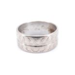A 1970s 18 ct white gold wedding band, ribbed and having engraved decoration, import mark for