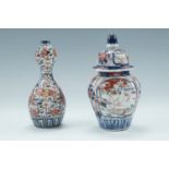 A Japanese Imari porcelain double gourd bottle vase, together with a similar covered jar, 17.5 cm