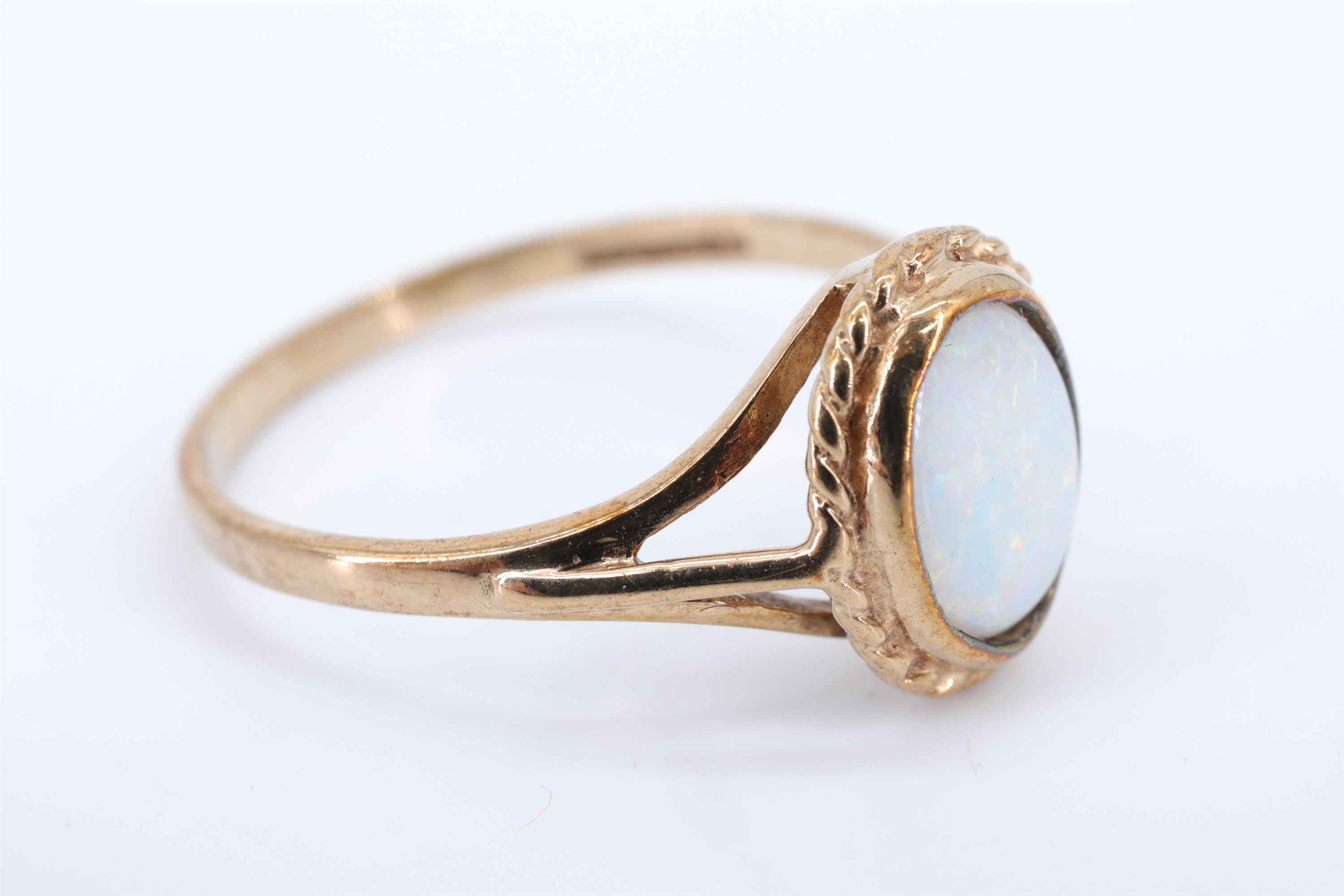 A lady's opal and 9 ct gold finger ring, having an oval opal in a rubbed over setting within a - Image 2 of 3
