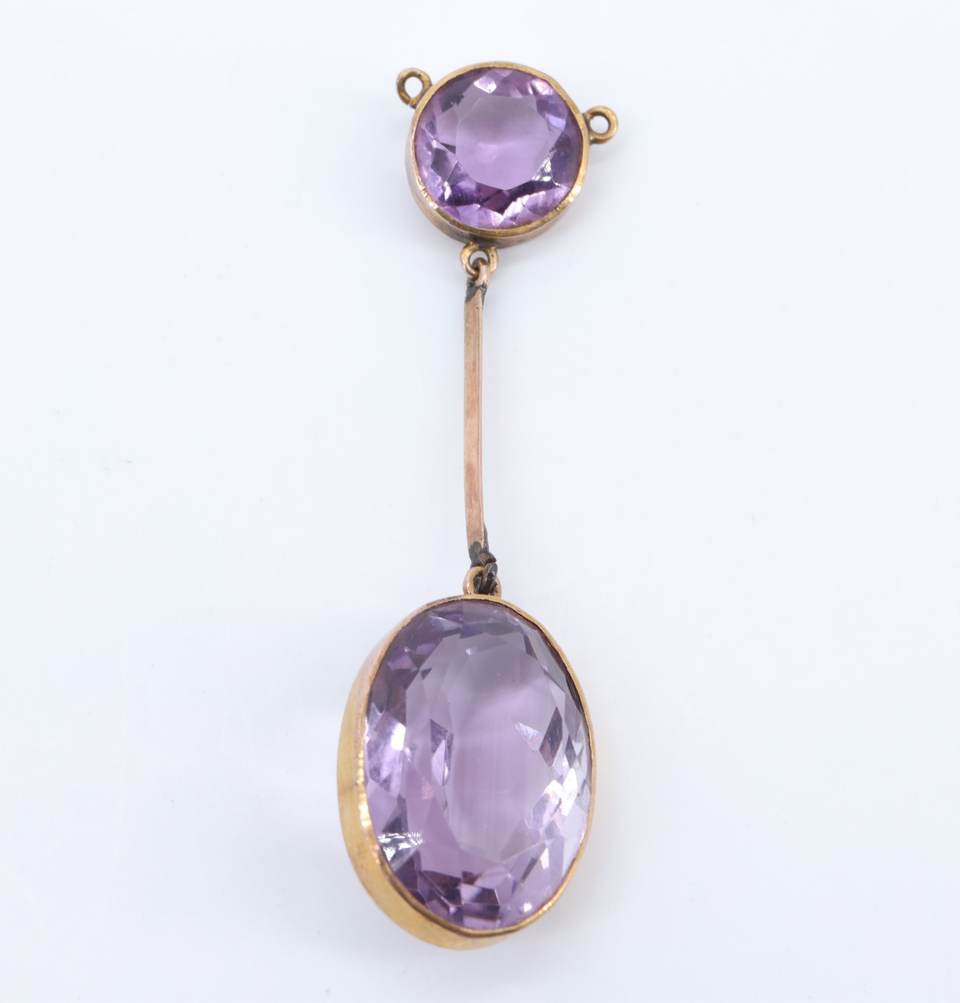 A late 19th / early 20th Century amethyst pendant, comprising a large facet-cut oval stone, bezel