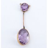 A late 19th / early 20th Century amethyst pendant, comprising a large facet-cut oval stone, bezel